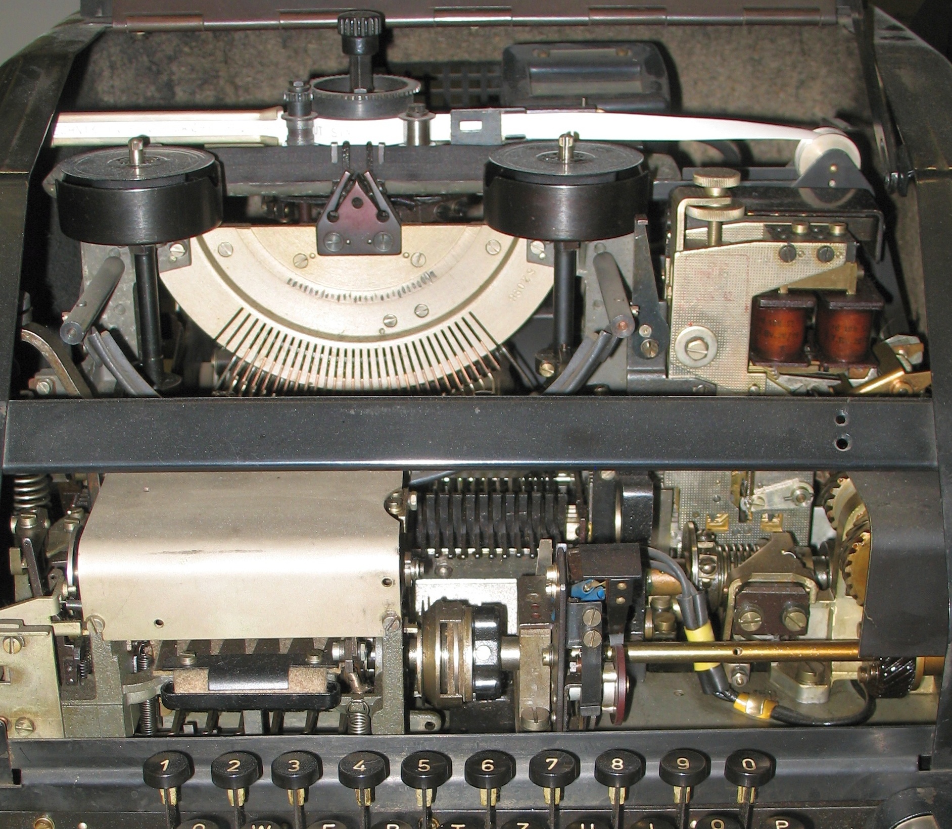 Figure 3 — The parts that do not survive storage: the platen and rollers of an opened printer. A platen is a steel core under a ground layer of rubber at a specified hardness, and that hardness is functional …