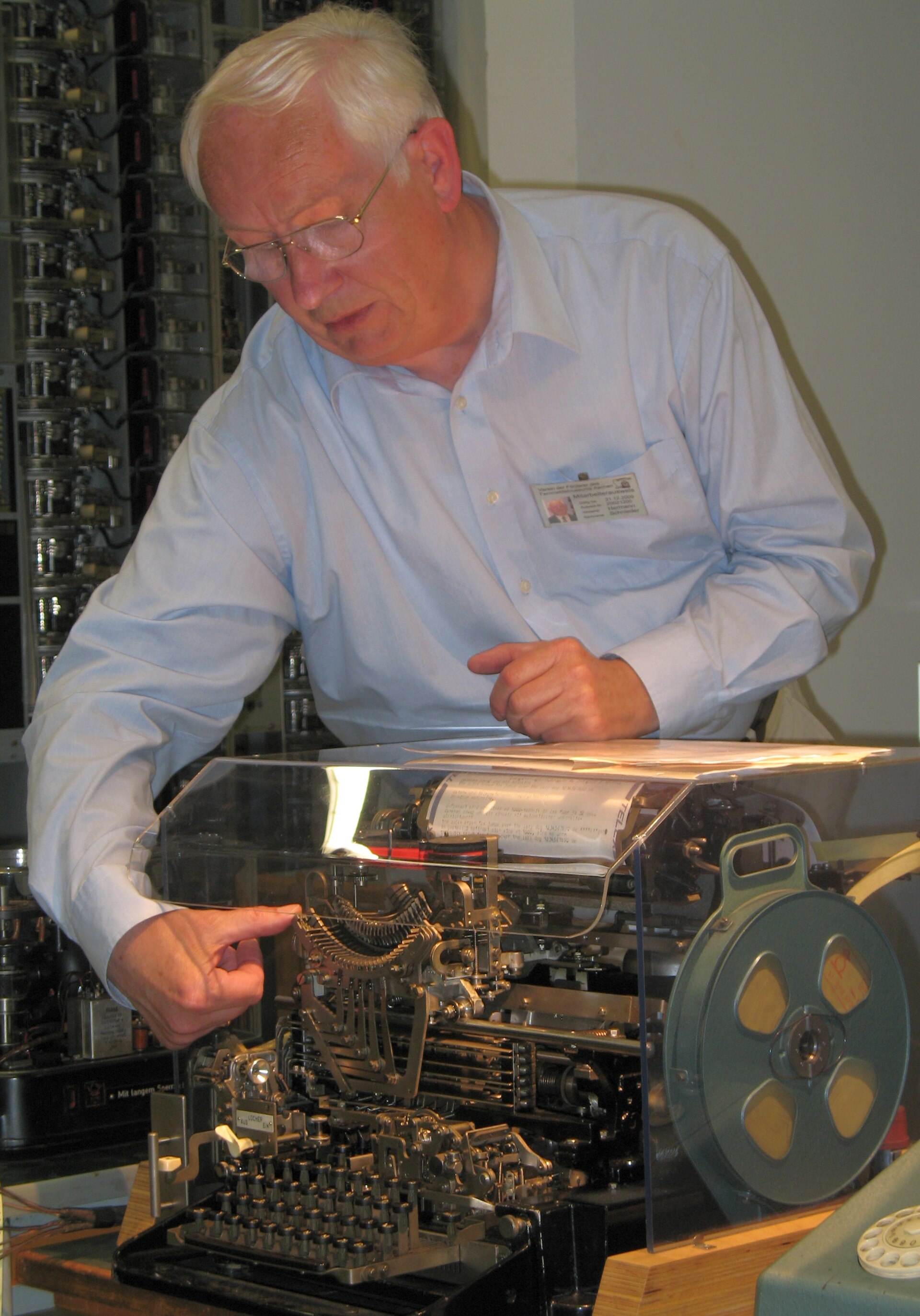 Figure 3 — A page printer opened for work, its typing unit exposed. Everything a restorer has to reach — the wiring, the perished rubber, the varnished lubricant, anything bent or missing — is only reachable …